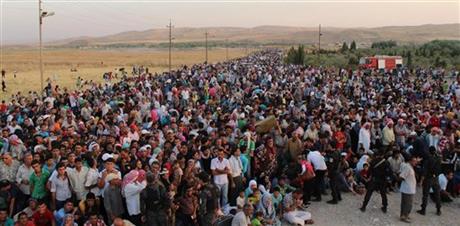 THOUSANDS OF SYRIANS FLEE TO IRAQ; CRISIS FEARED