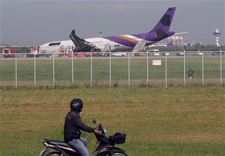 THAI AIRWAYS SKIDS OFF RUNWAY; 14 PASSENGERS HURT