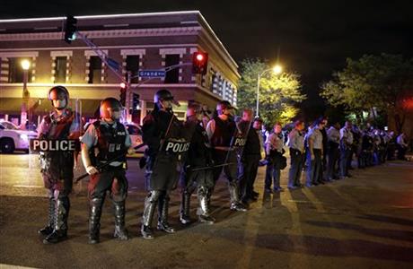 Angry protesters yell at riot police in St. Louis