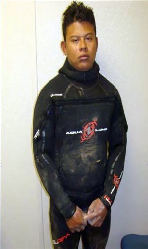 This April 25, 2015 photo, from the U.S. Border Patrol and introduced as evidence in U.S. District Court, Evelio Padilla, a Honduran national, in a wetsuit after his arrest for attempting to smuggle over 50 pounds of cocaine into the U.S. from Mexico by way of a partly-underwater tunnel that crossed the border into a canal near Calexico, Calif. Padilla pleaded guilty Wednesday, Aug. 19, in federal court in San Diego to one count of possession of drugs with intent to distribute. (U.S. Border Patrol via AP)