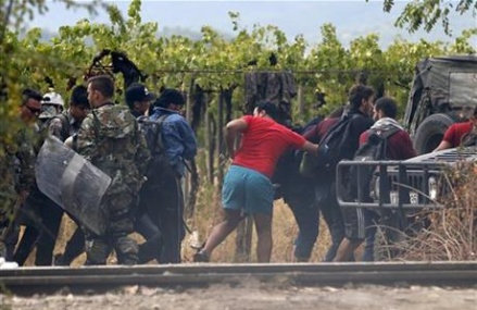 Thousands of migrants rush past police into Macedonia