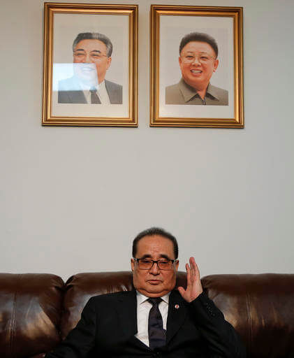 Seated under portraits of former North Korean Leaders Kim Il Sung, left, and Kim Jong Il, North Korea's Foreign Minister Ri Su Yong answers questions during an interview, Saturday, April 23, 2016, at the country's Permanent Mission to the United Nations in New York. (AP Photo/Julie Jacobson)