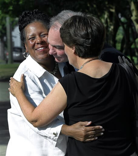 A fellow parishoner, left of St. Elizabeth's Catholic Church in Richmond, Va. greets Sen. Tim Kaine, center, and his wife, Anne Holton as they arrive for Mass St. Elizabeth Catholic Church, their longtime parish, his debut as Hillary Clinton's running mate, Sunday, July 24, 2016. (P. Kevin  Morley/Richmond Times-Dispatch via AP)