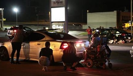 Car hits protester in Ferguson, shots ring out